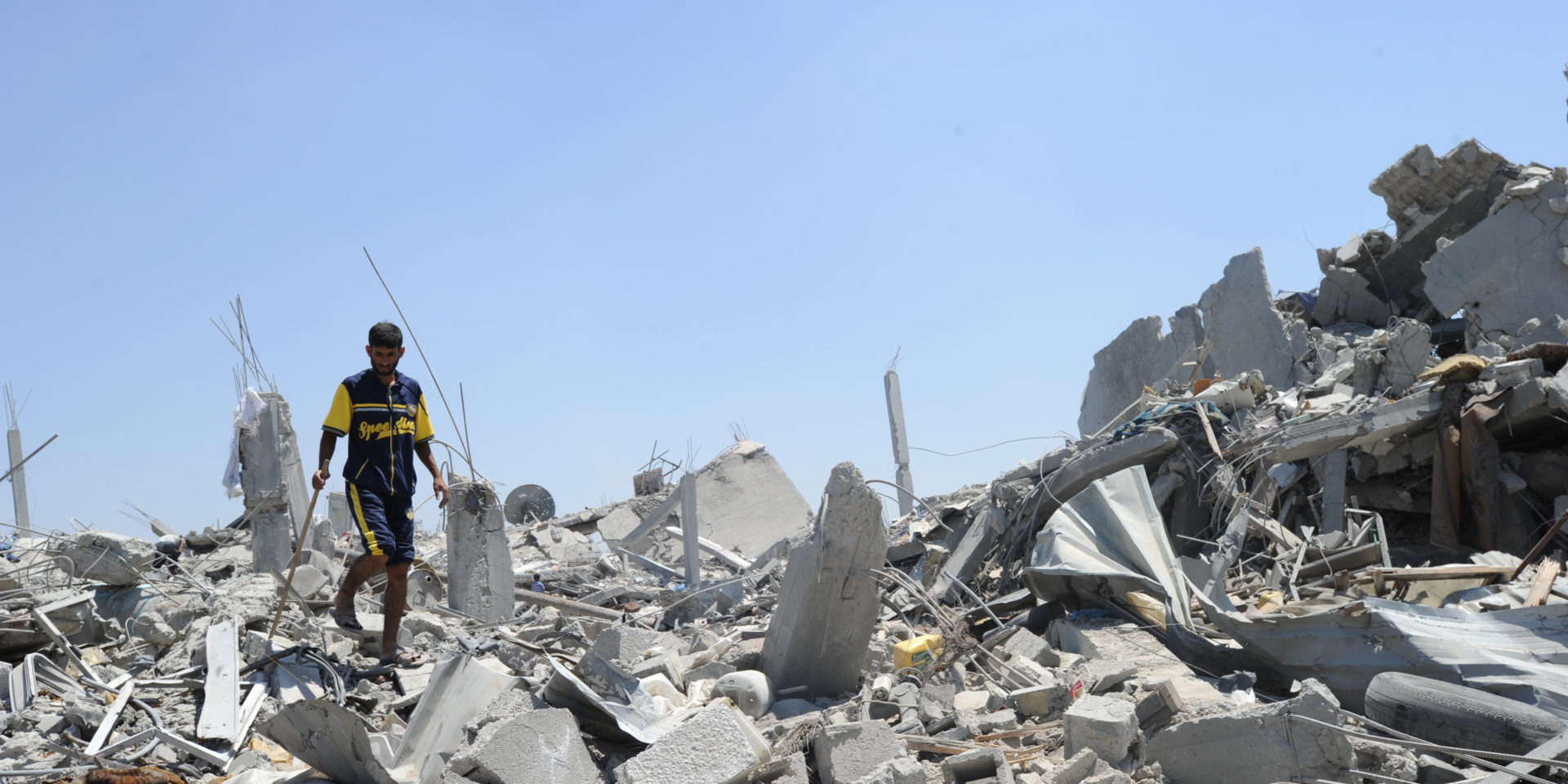 Palestinians searches through rubble