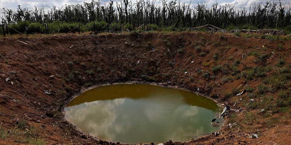 crater_ukr_env_960 A large crater, filled with water, shows the severity of the physical damage to Ukraine's landscape.