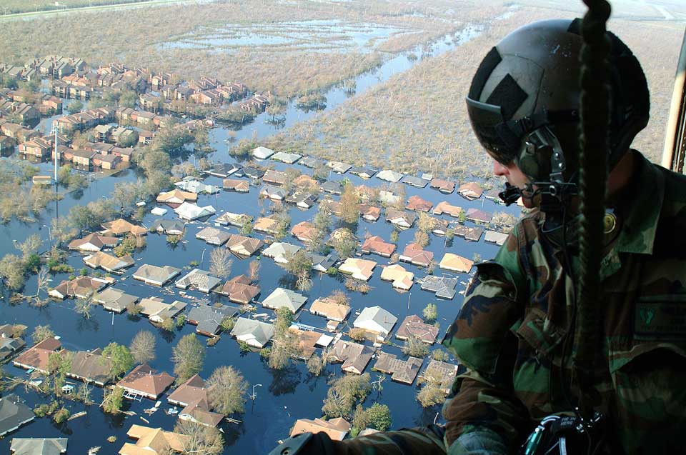 A soldier looks out of a helicopter above the Hurrican Katrina floods, which have engulfed residential areas of New Orleans.