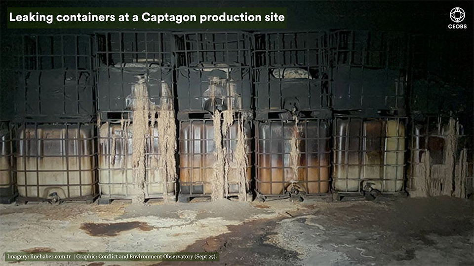 A row of one tonne poly caged bowsers stacked two high, the top layer are stained grey, some on the lower layer are still white in places. Several show a white solidified discharge, this is also coating much of the concrete floor in layers of white residue. It's a grim scene.
