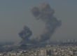 A large exposion and smoke plume visible in the Tehran skyline.